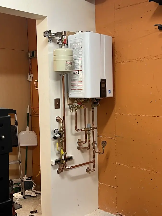 Plumbing technician inspecting water heater connections in Boulder City